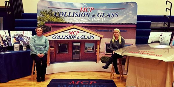Two MCP Collision & Glass staff members at the shop, ready to help with an insurance estimate
